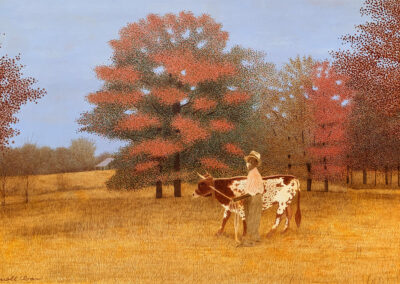 A person leads a spotted cow across a golden field, with red and orange autumn trees in the background under a blue sky.
