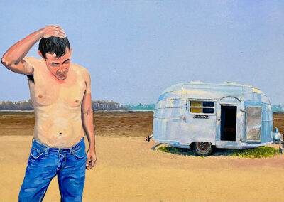 A shirtless man in jeans stands scratching his head on a barren landscape, with a small silver trailer nearby. The scene appears isolated under a clear sky with distant trees on the horizon.